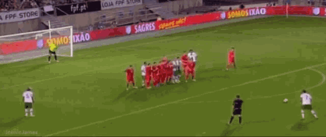 a soccer game is being played in front of an advertisement for loja fpf store