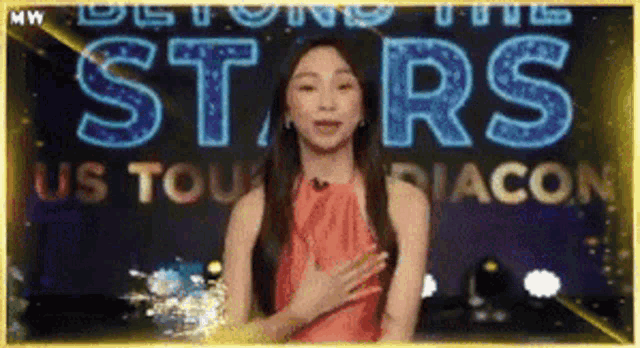 a woman stands in front of a sign that says beyond the stars us tour