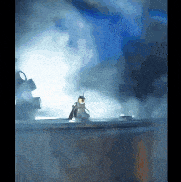 a penguin is sitting on top of a metal object with a blue sky in the background