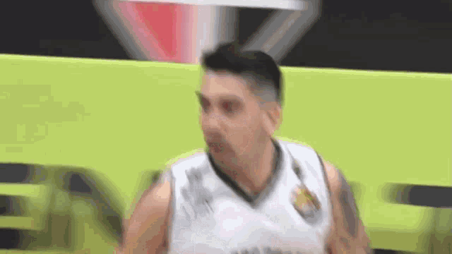 a man in a basketball jersey is standing on a court .