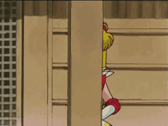 a cartoon character named sailor moon is peeking out from behind a wall