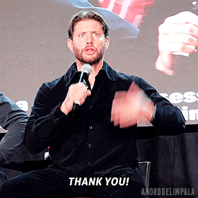 a man holding a microphone says thank you