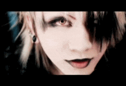 a close up of a person 's face with a very dark makeup .