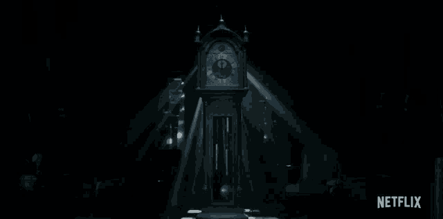 a clock in a dark room with a netflix logo
