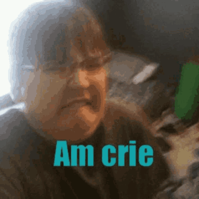 a man with glasses is making a funny face with the words `` am crie '' written on the bottom .