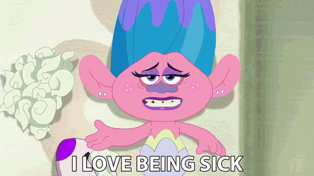 a troll laying on a bed with the words " i love being sick " next to her