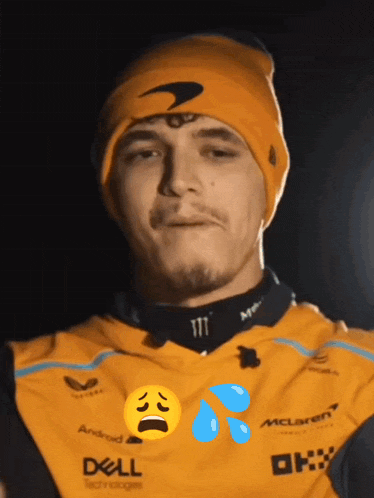 a man wearing a beanie and a mclaren shirt