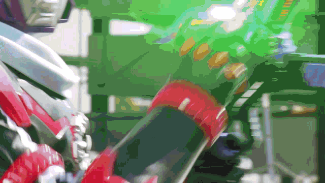 a blurred image of a person holding a red object with a green background