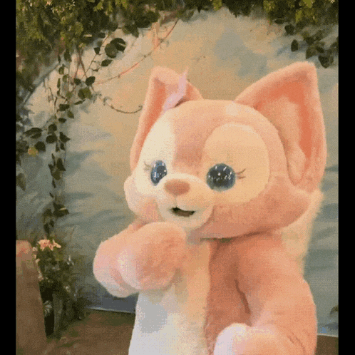 a stuffed animal is standing in front of a wall
