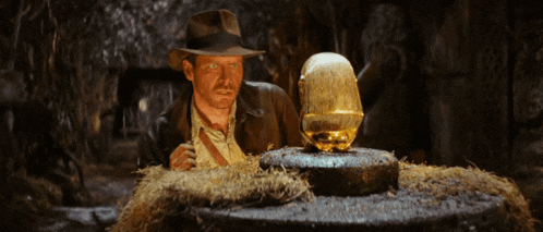 a man in a hat is looking at a statue