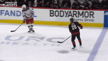 a hockey player with the number 20 on his jersey stands on the ice