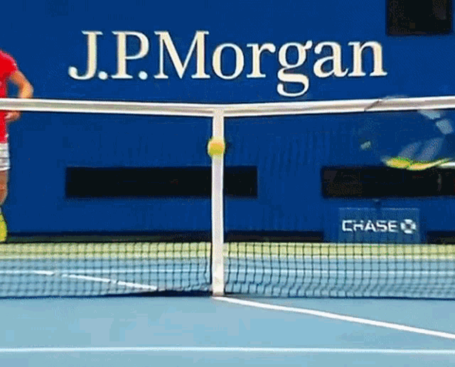 a tennis court with a j.p. morgan sign behind the net