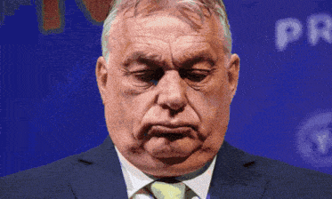 a man in a suit and tie is making a face