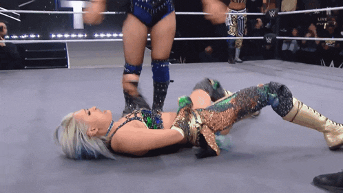 a woman in a wrestling ring with the word live on the bottom