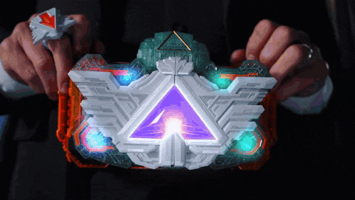 a person is holding a toy with a purple triangle in the middle
