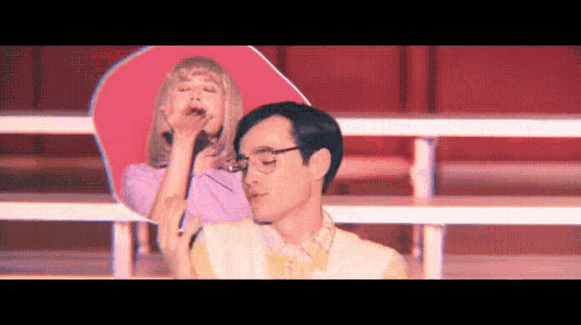 a man and woman are standing next to each other on a stage .