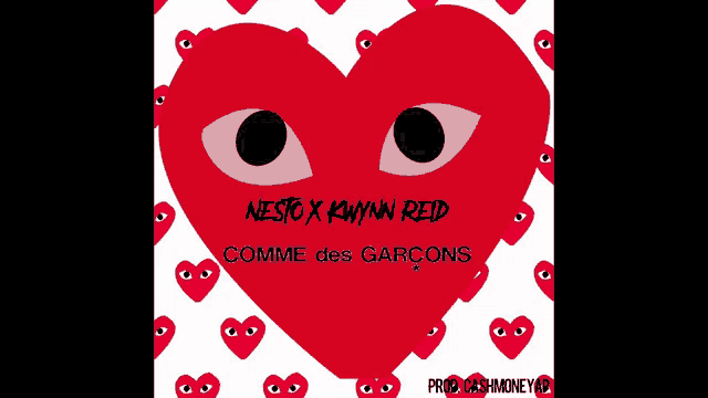 a red heart with eyes on it and the words comme des garcons