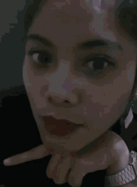 a blurry picture of a person 's face with a purple background .