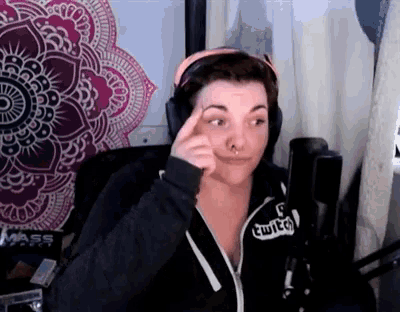 a woman wearing headphones and a sweatshirt that says twitch
