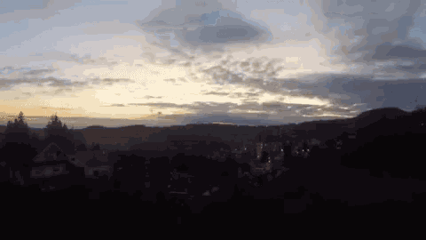 a sunset with a few clouds in the sky