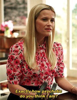 a woman in a pink floral shirt is sitting at a table and says exactly how psychotic do you think i am