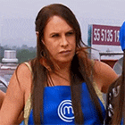 a woman wearing a blue apron is standing in front of a sign that says 55 5136 15 .