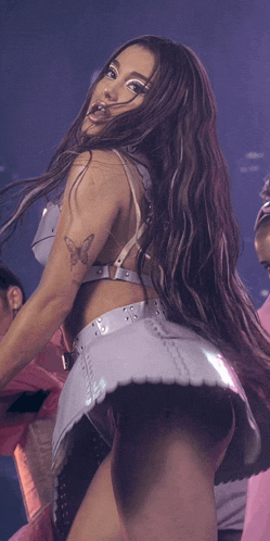 a woman with long hair and a tattoo on her arm