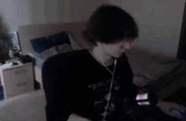 a blurry picture of a man wearing headphones and a black shirt