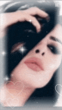 a close up of a woman 's face with hearts around her and the letter m on the bottom