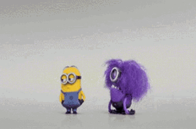 two purple minions are standing next to each other