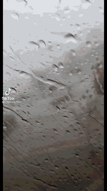 a tiktok video of a car windshield with rain drops on it