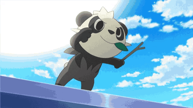 a panda bear with a stick in its mouth