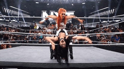 two women are wrestling in a ring with the letter n on the ring