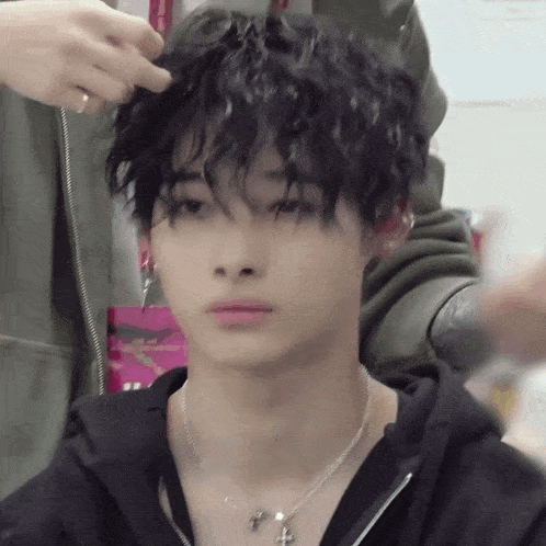 a close up of a person getting their hair done by a hairdresser .