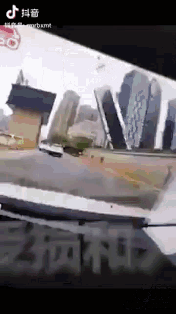 a car is driving down a street in front of a large building that says ' lvmt ' on it