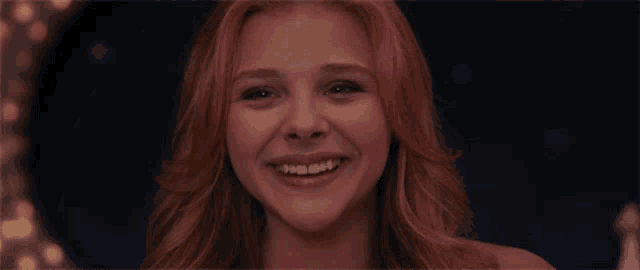 a close up of a woman 's face smiling