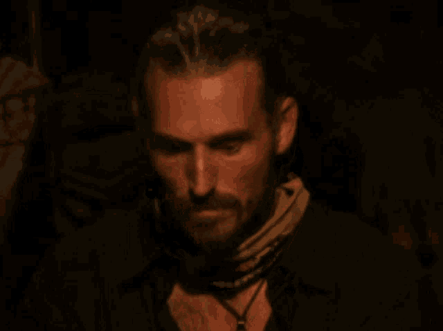 a man with a beard is wearing a scarf around his neck