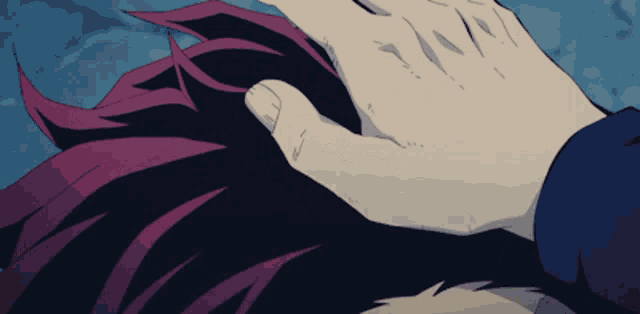 a close up of a person 's hand on a person 's hair