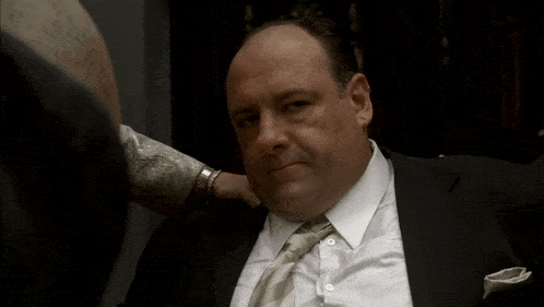 a man in a suit and tie has a hand on his neck
