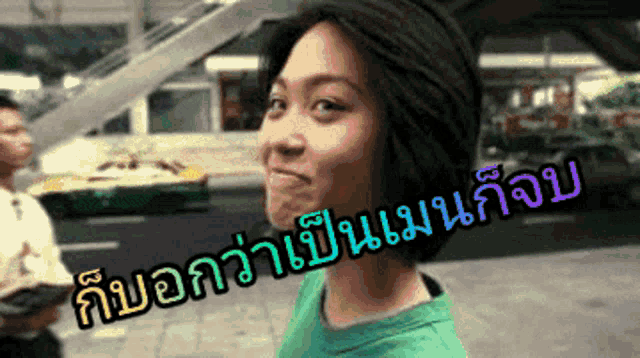 a woman in a green shirt is making a funny face in front of a taxi in a city