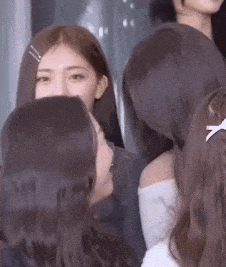 a group of women are standing next to each other and talking .