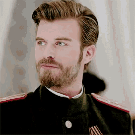 a man with a beard is wearing a uniform