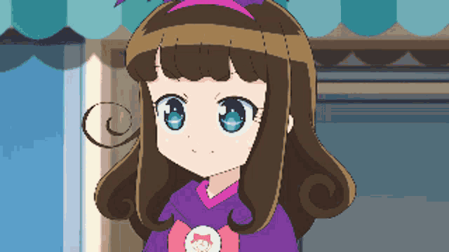 a little girl with brown hair and blue eyes is wearing a purple shirt