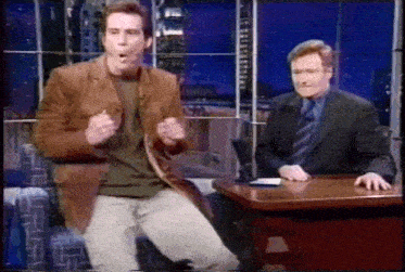 a man in a brown jacket is dancing in front of a man in a suit