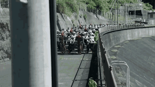 a large group of soldiers are walking down a road