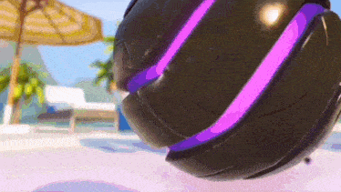 a black object with purple stripes on it is sitting on a beach