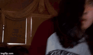 a close up of a person 's face in a dark room .