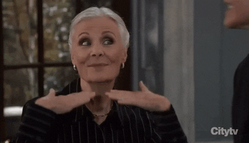 a woman making a face with her hands in front of a citytv ad