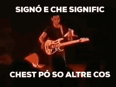 a man is playing a guitar in a dark room with the words chest po so altre cos on the bottom