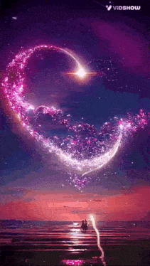 a couple sitting on a beach with a heart made of stars in the sky